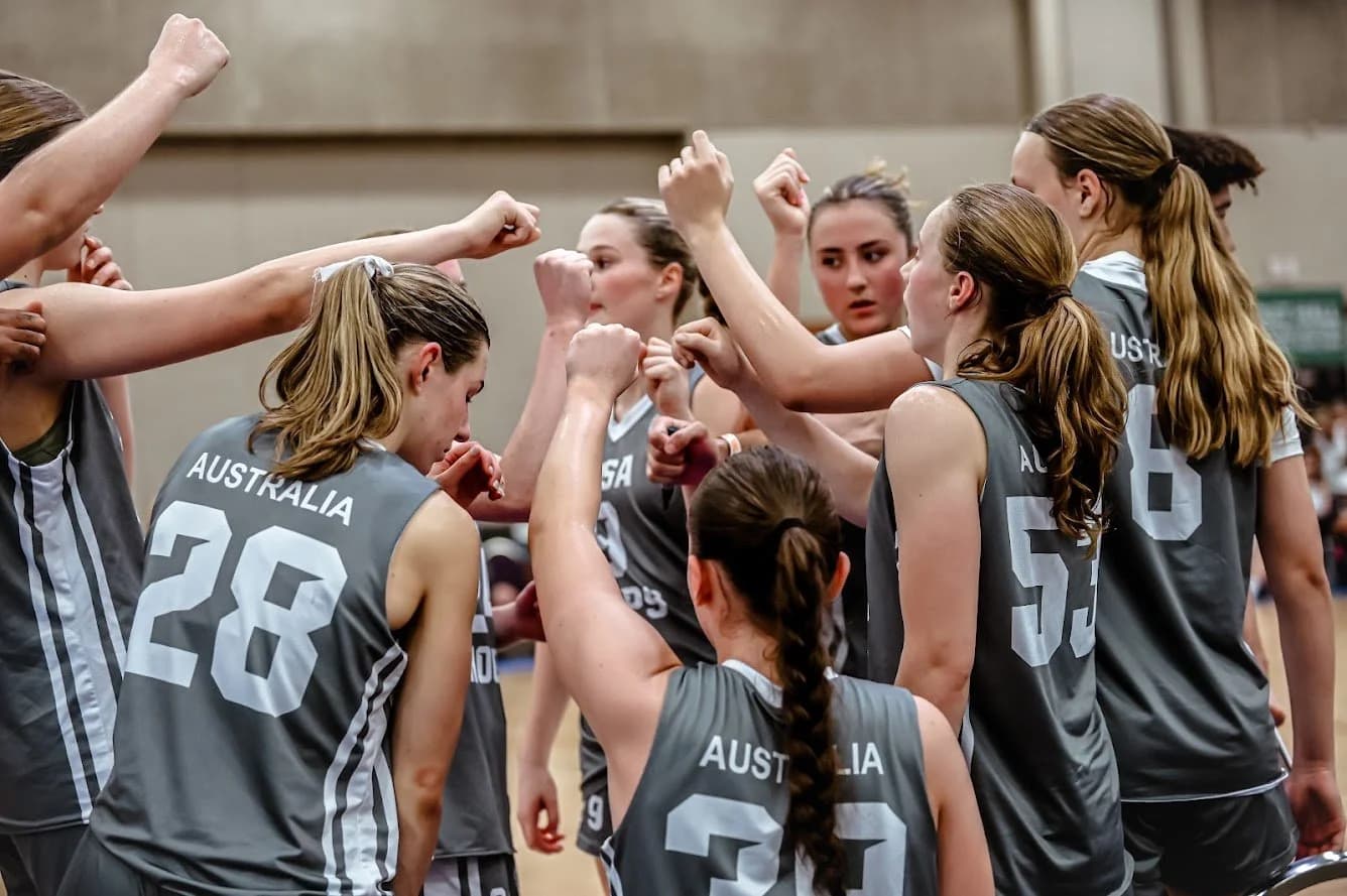 An AUSA Hoops girls squad celebrating together after a game