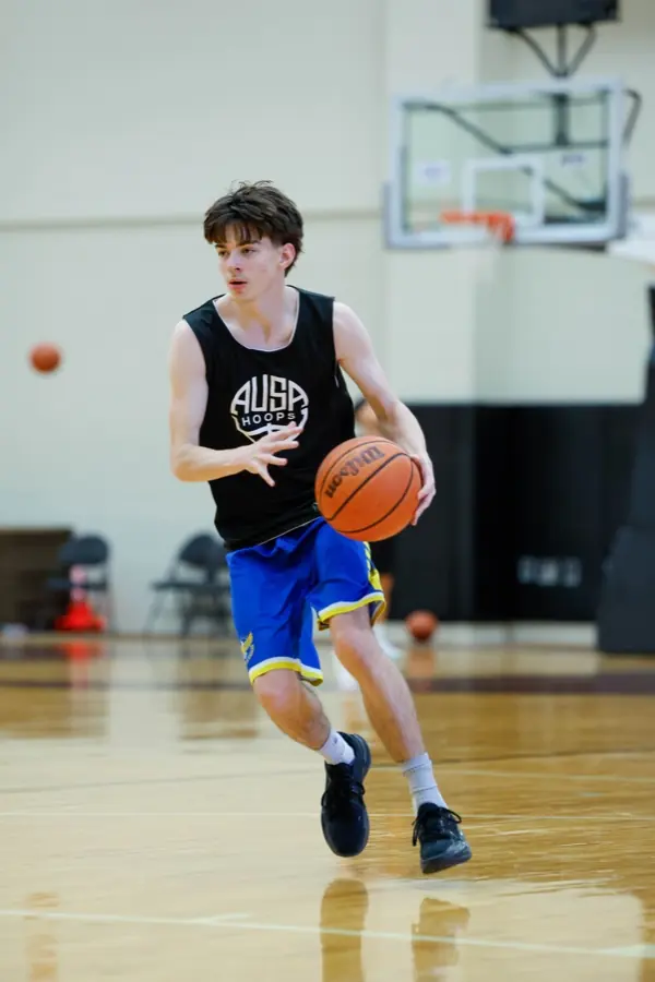 Player in an AUSA Hoops singlet driving the ball at a trial session